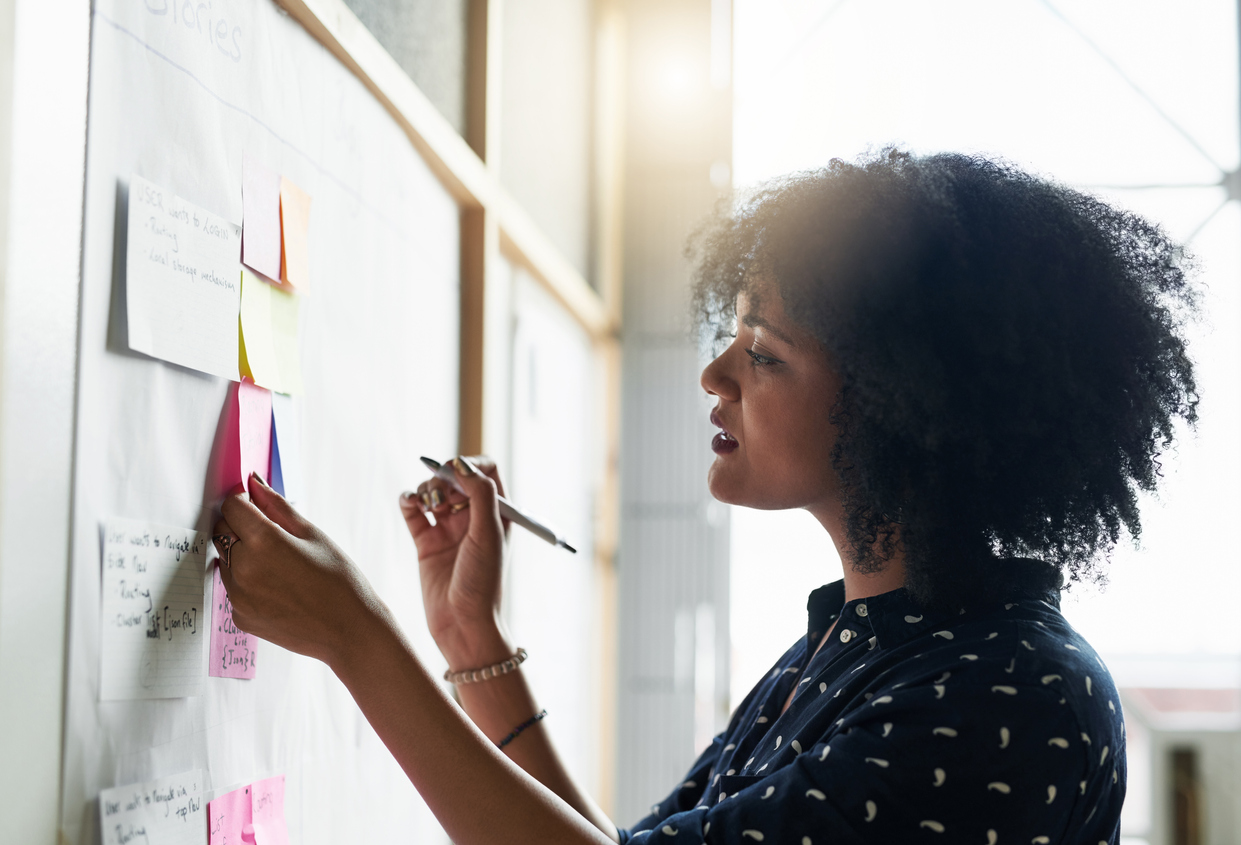 Shot Of A Young Female Designer Working In Her Office Planning An Event